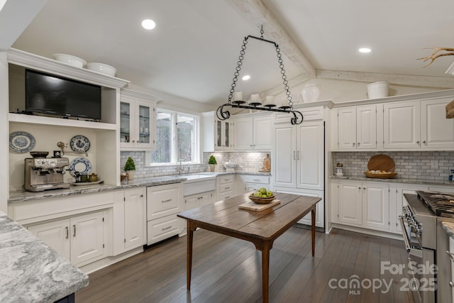 kitchen with glass insert cabinets, dark wood-style floors, white cabinetry, vaulted ceiling with beams, and high end range