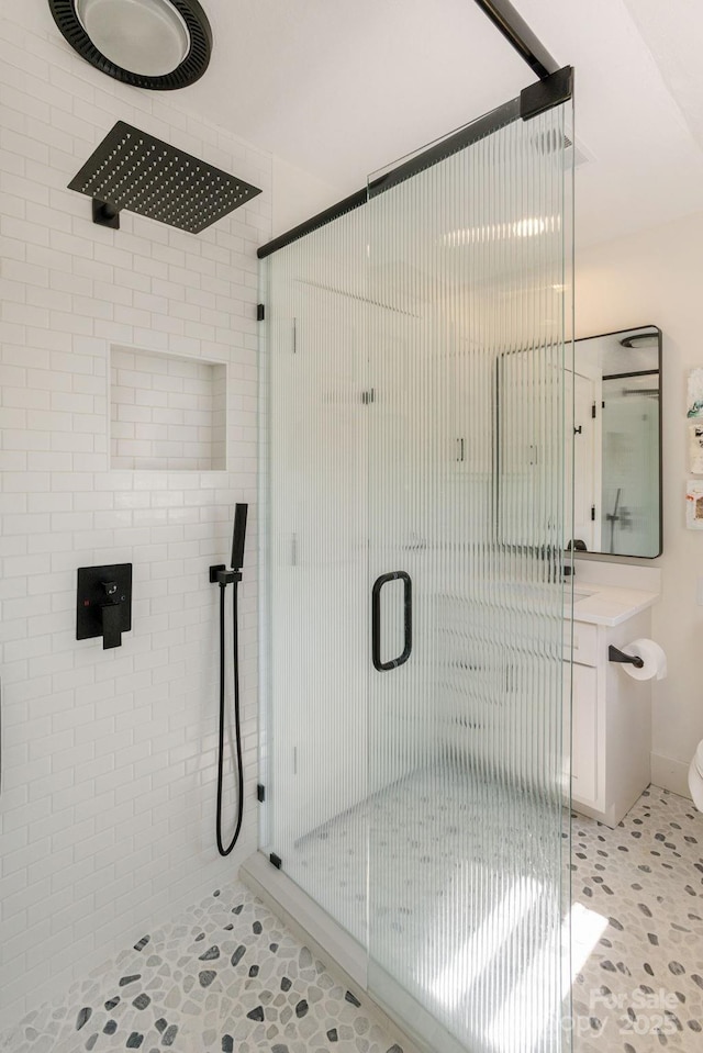 bathroom with toilet and a stall shower