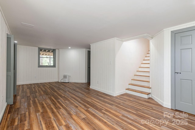 basement with baseboards, stairway, and wood finished floors
