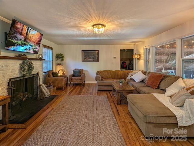 317 Balsam Dr, Waynesville, NC 28786 - living area featuring a fireplace with raised hearth, baseboards, and wood finished floors
