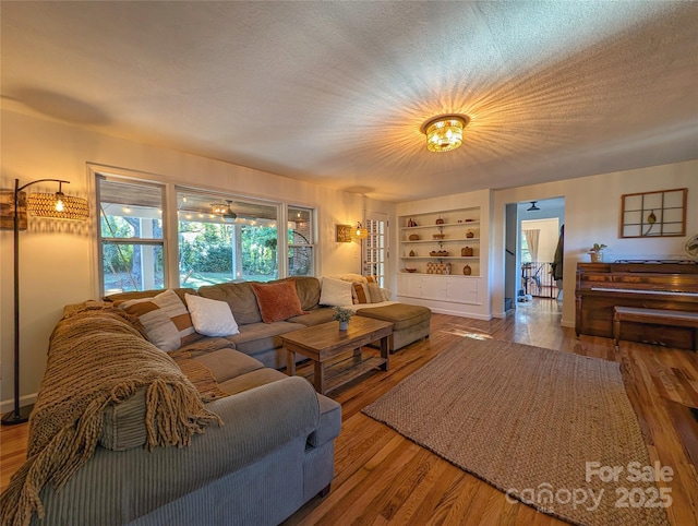 317 Balsam Dr, Waynesville, NC 28786 - living room with built in shelves and wood finished floors