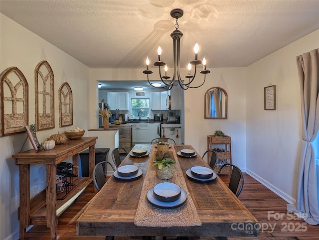 317 Balsam Dr, Waynesville, NC 28786 - dining area featuring baseboards, a textured ceiling, a chandelier, and dark wood finished floors