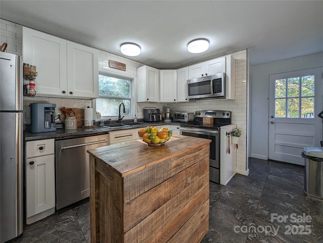 317 Balsam Dr, Waynesville, NC 28786 - kitchen featuring appliances with stainless steel finishes, backsplash, plenty of natural light, and wooden counters