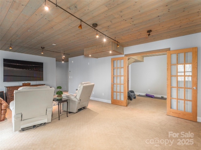 living area featuring rail lighting, french doors, wooden ceiling, and carpet floors