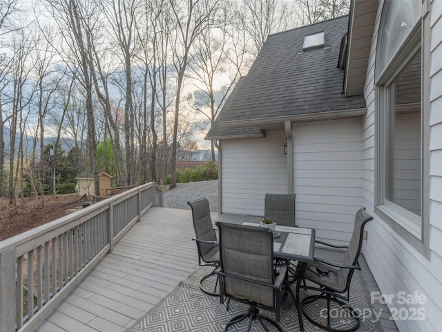 wooden terrace with outdoor dining area