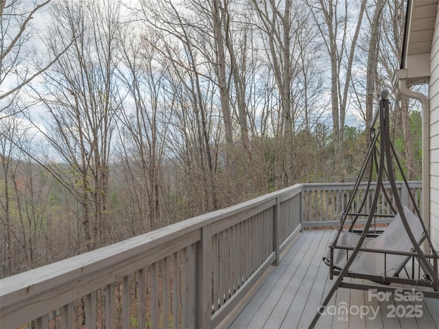 wooden deck featuring a view of trees