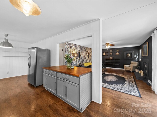 kitchen featuring dark wood finished floors, gray cabinets, freestanding refrigerator, wood counters, and ceiling fan