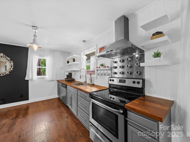 kitchen with gray cabinetry, wooden counters, stainless steel appliances, and open shelves