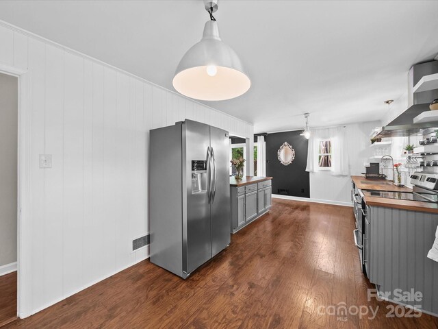 kitchen with gray cabinetry, butcher block countertops, open shelves, and stainless steel appliances