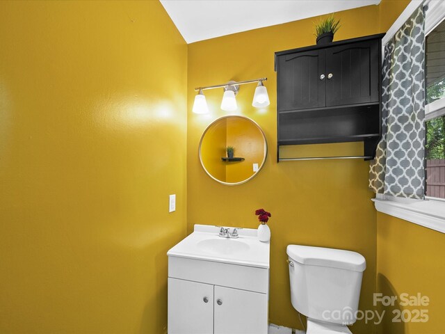 bathroom featuring toilet and vanity