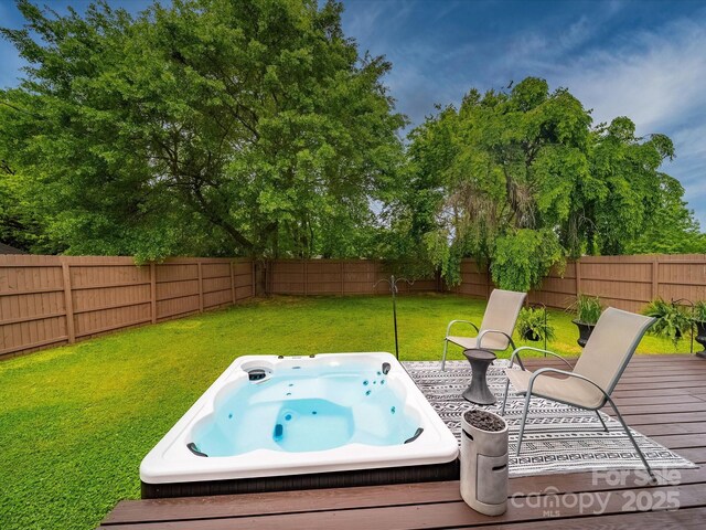 wooden terrace with a lawn, a fenced backyard, and an outdoor hot tub