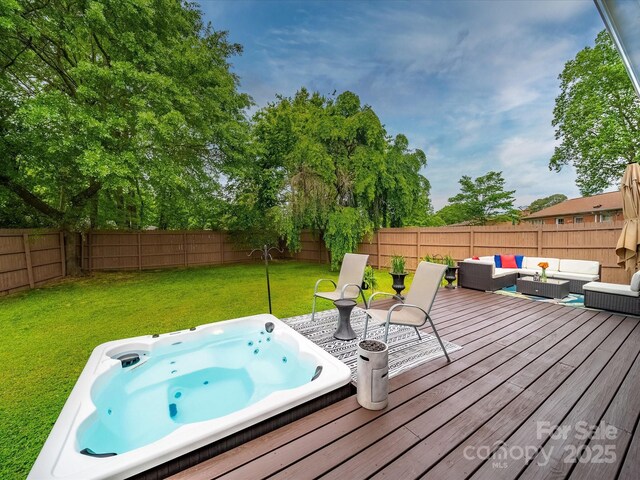 wooden deck with an outdoor living space, a lawn, a fenced backyard, and an outdoor hot tub