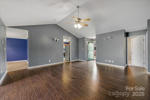 unfurnished living room with wood finished floors, baseboards, a ceiling fan, and lofted ceiling