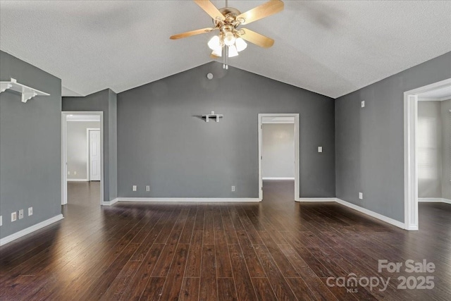 empty room featuring lofted ceiling, dark wood-style flooring, baseboards, and ceiling fan