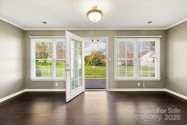 doorway with wood finished floors, baseboards, visible vents, and a wealth of natural light