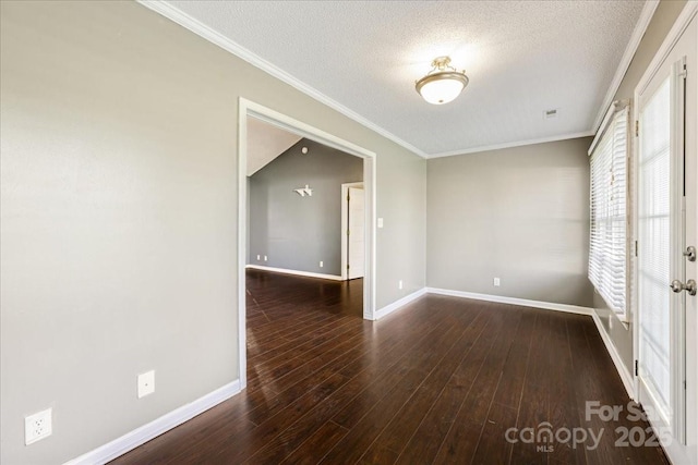 unfurnished room with ornamental molding, baseboards, and wood finished floors