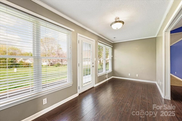 interior space with crown molding, hardwood / wood-style floors, baseboards, and a textured ceiling