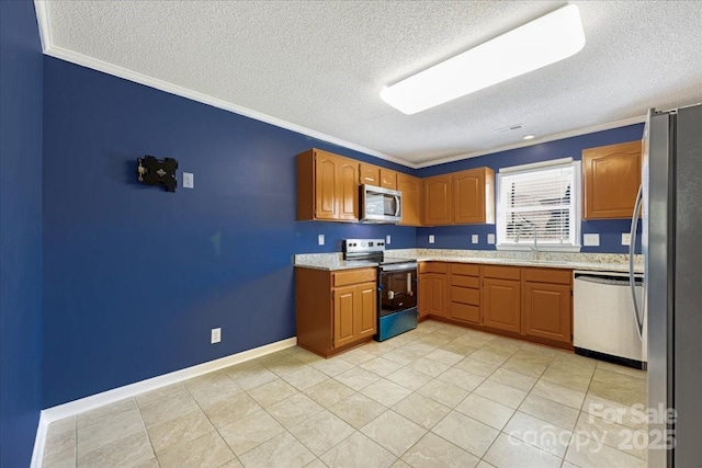 kitchen with brown cabinetry, a textured ceiling, appliances with stainless steel finishes, and crown molding