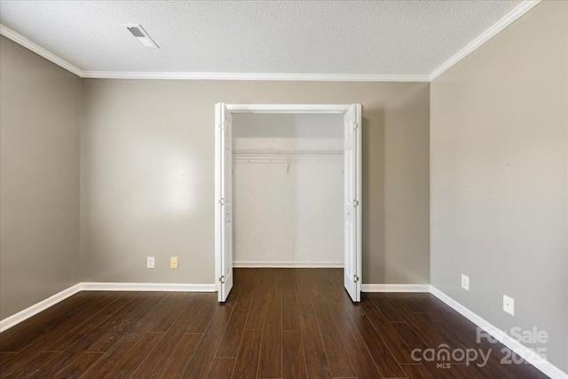 unfurnished bedroom featuring visible vents, a closet, wood finished floors, and a textured ceiling