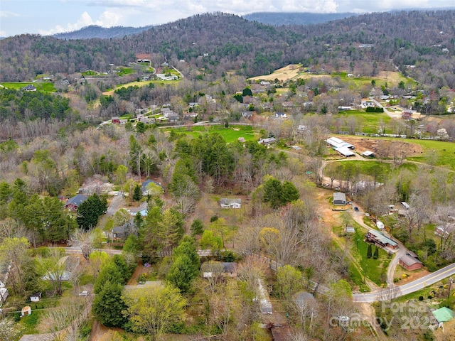 birds eye view of property featuring a mountain view and a view of trees