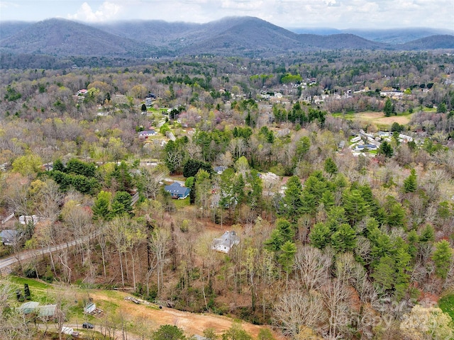 birds eye view of property featuring a wooded view and a mountain view