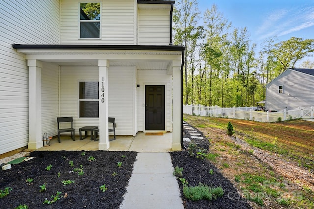 11040 E Lake Rd, Charlotte, NC 28215 - view of exterior entry with a porch and fence