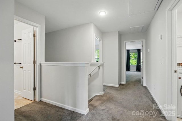 11040 E Lake Rd, Charlotte, NC 28215 - hallway featuring washer / dryer, baseboards, an upstairs landing, and carpet flooring
