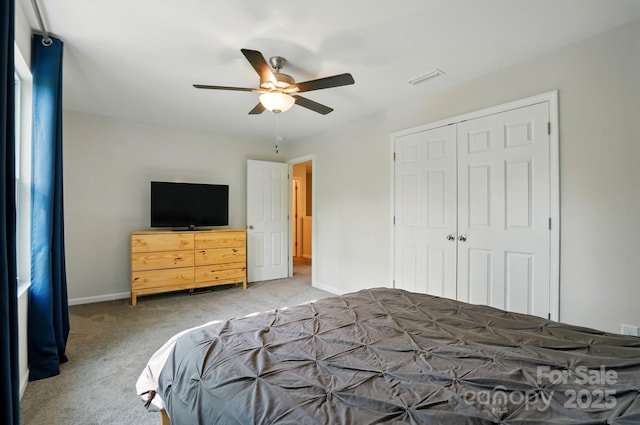 11040 E Lake Rd, Charlotte, NC 28215 - carpeted bedroom with a closet, baseboards, a ceiling fan, and visible vents