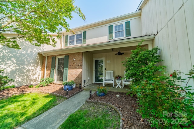 6809 Copernicus Cir, Charlotte, NC 28226 - doorway to property with ceiling fan, covered porch, and brick siding