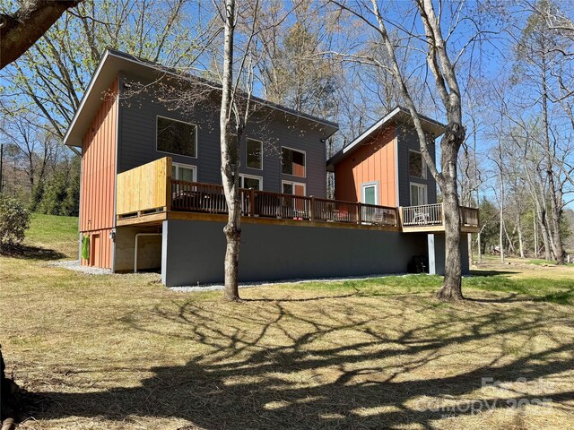 8061 State Highway 80 S, Burnsville, NC 28714 - back of house with a yard, a wooden deck, and board and batten siding