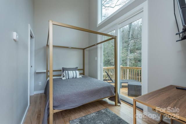 8061 State Highway 80 S, Burnsville, NC 28714 - bedroom featuring access to exterior, baseboards, and wood finished floors