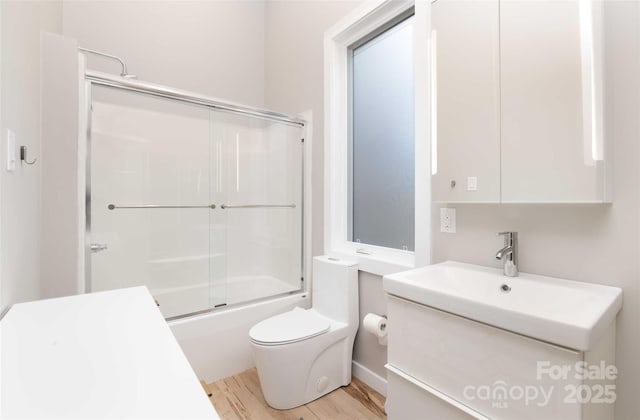 8061 State Highway 80 S, Burnsville, NC 28714 - full bath featuring shower / bath combination with glass door, vanity, toilet, and wood finished floors