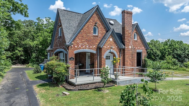 115 12th St SW, Hickory, NC 28602 - view of front of property with a chimney, brick siding, a shingled roof, and a front lawn