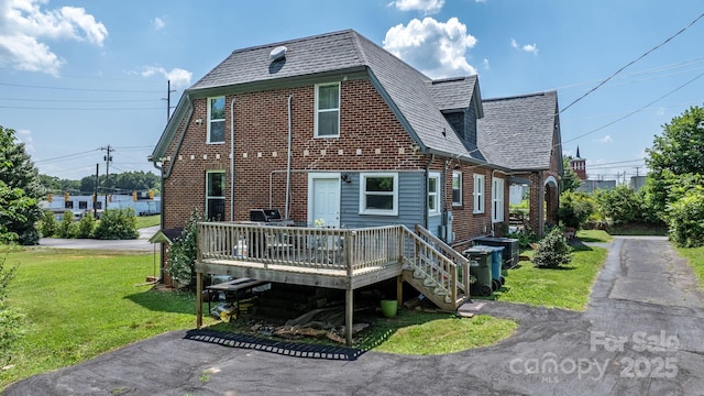 115 12th St SW, Hickory, NC 28602 - rear view of house featuring a yard, a deck, a shingled roof, and brick siding