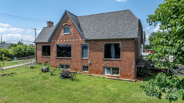 115 12th St SW, Hickory, NC 28602 - rear view of property with roof with shingles, a fire pit, brick siding, and a chimney