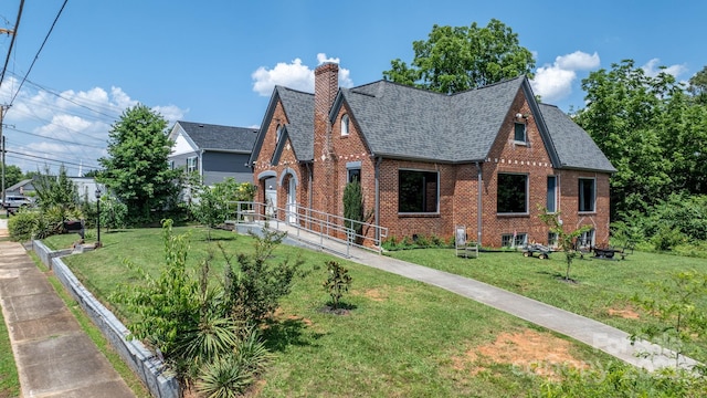 115 12th St SW, Hickory, NC 28602 - view of front facade with brick siding, a chimney, a front lawn, and a shingled roof