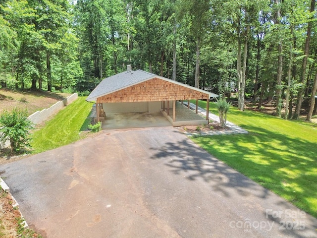 125 Dutchman Creek Rd, Elkin, NC 28621 - surrounding community featuring asphalt driveway, a carport, a yard, and a wooded view