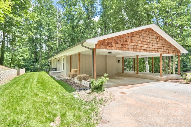 125 Dutchman Creek Rd, Elkin, NC 28621 - view of side of home featuring driveway, a lawn, and an attached carport