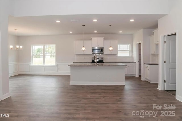 184 Swann Rd Unit 1, Statesville, NC 28625 - kitchen featuring white cabinetry, dark wood-style flooring, stainless steel appliances, a center island with sink, and backsplash