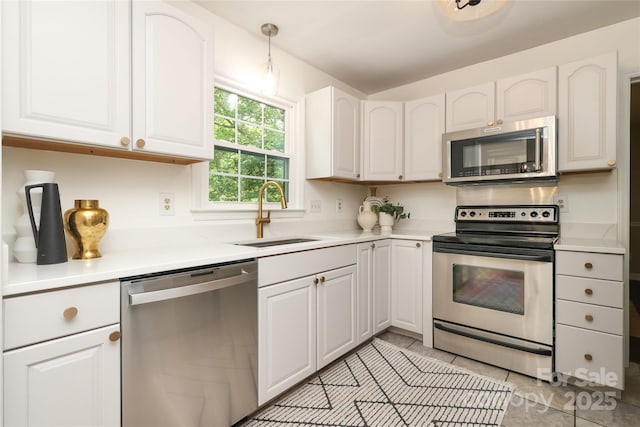 2413 Bergen Ct, Charlotte, NC 28210 - kitchen featuring a sink, light tile patterned flooring, white cabinetry, light countertops, and appliances with stainless steel finishes