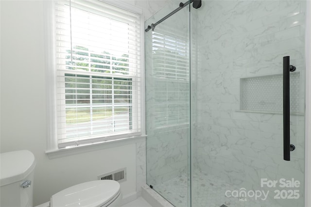 2413 Bergen Ct, Charlotte, NC 28210 - bathroom featuring plenty of natural light, visible vents, a shower stall, and toilet