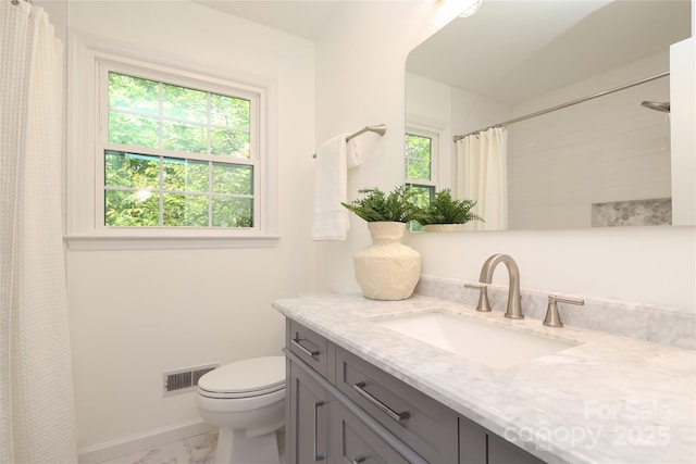 2413 Bergen Ct, Charlotte, NC 28210 - full bath featuring marble finish floor, a wealth of natural light, toilet, and visible vents