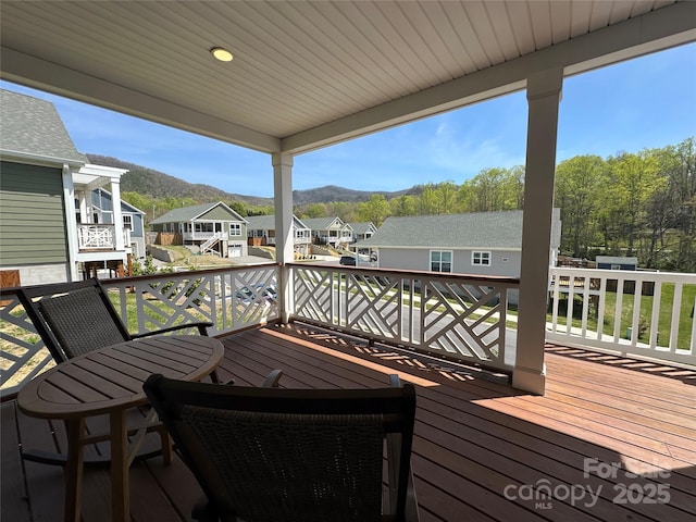 deck featuring a residential view and a mountain view