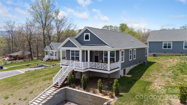 back of property featuring central AC unit, a porch, a lawn, stairway, and board and batten siding