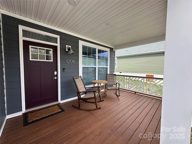 wooden terrace featuring covered porch