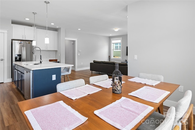 dining space featuring baseboards, recessed lighting, and dark wood finished floors