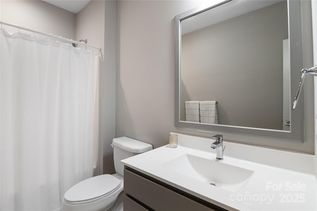 full bathroom with vanity, curtained shower, and toilet