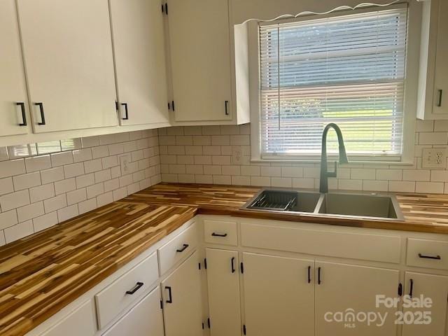 1026 Garden St SE, Lenoir, NC 28645 - kitchen featuring a sink, white cabinets, tasteful backsplash, and butcher block counters