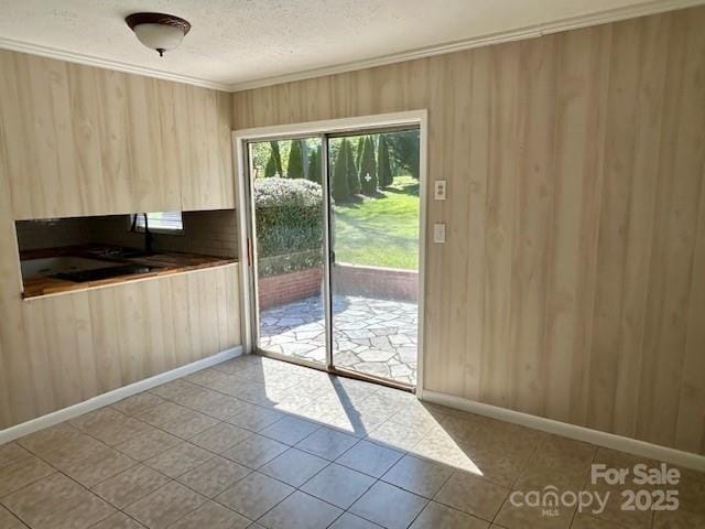 1026 Garden St SE, Lenoir, NC 28645 - doorway with a textured ceiling, crown molding, baseboards, and tile patterned flooring