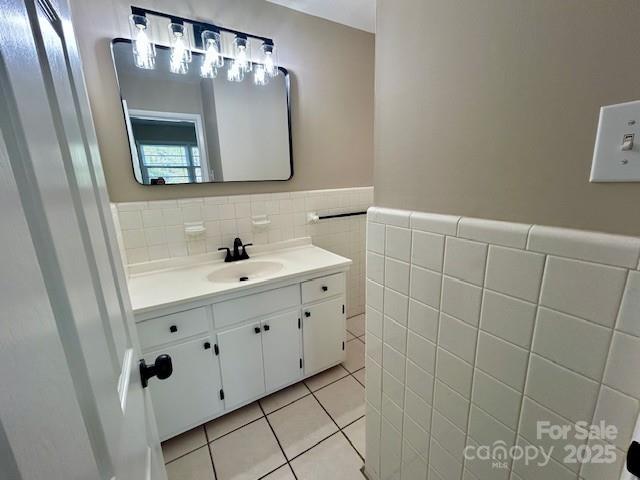 1026 Garden St SE, Lenoir, NC 28645 - bathroom with tile walls, tile patterned floors, vanity, and a wainscoted wall
